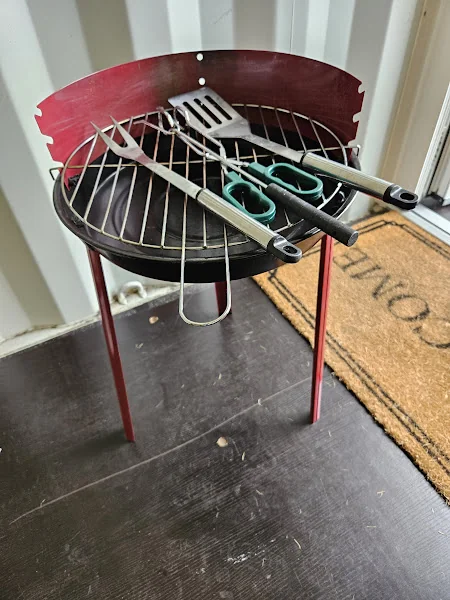 Portable BBQ with tools for outdoor cooking